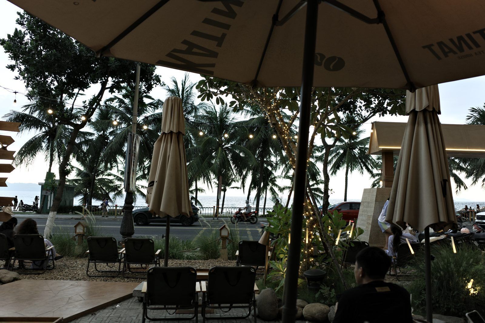 Beachfront cafe with palm trees overlooking My Khe Beach in Da Nang