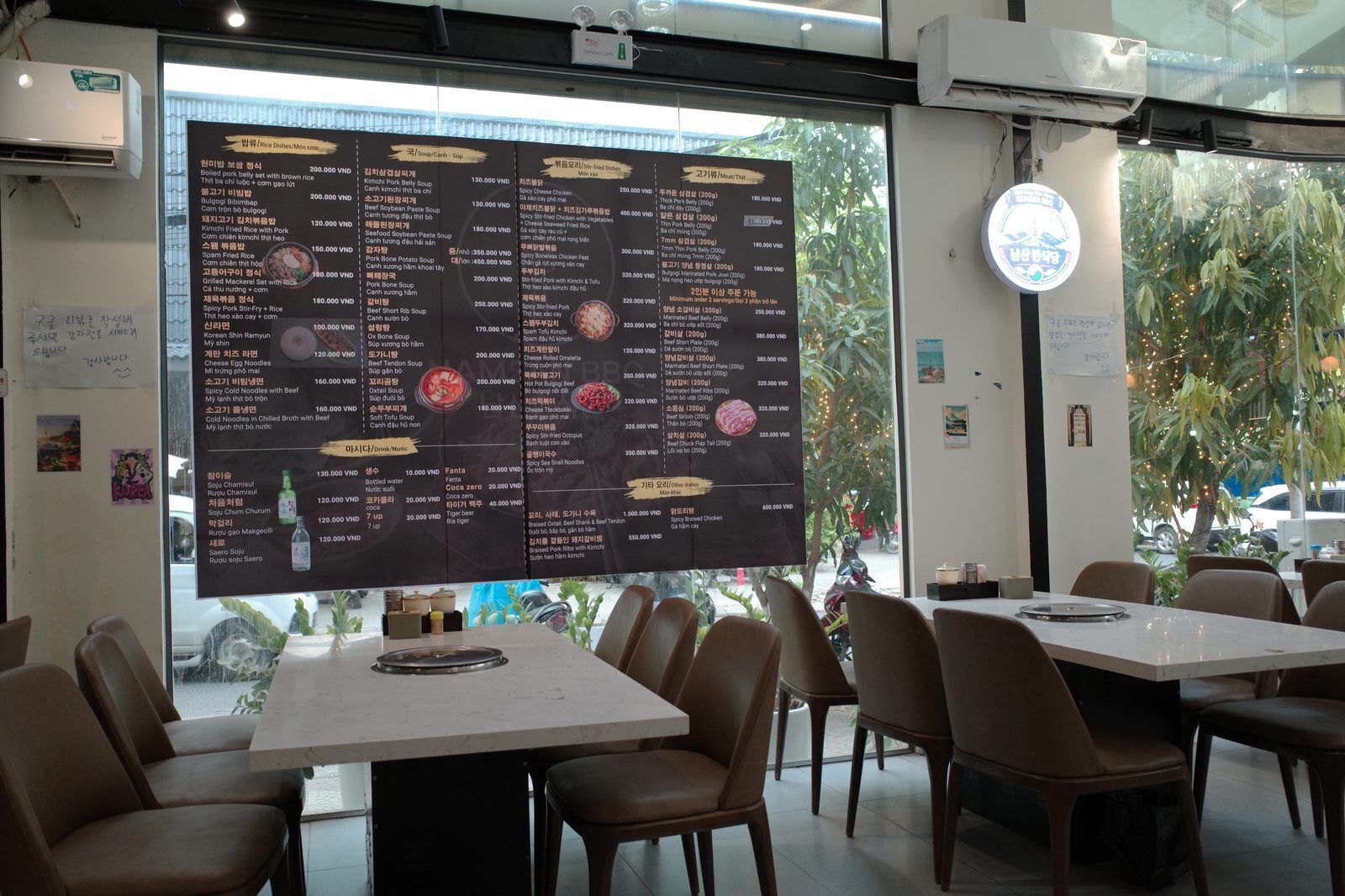 Korean restaurant menu board in Da Nang showing rice dishes, soups and BBQ meat prices in Vietnamese dong