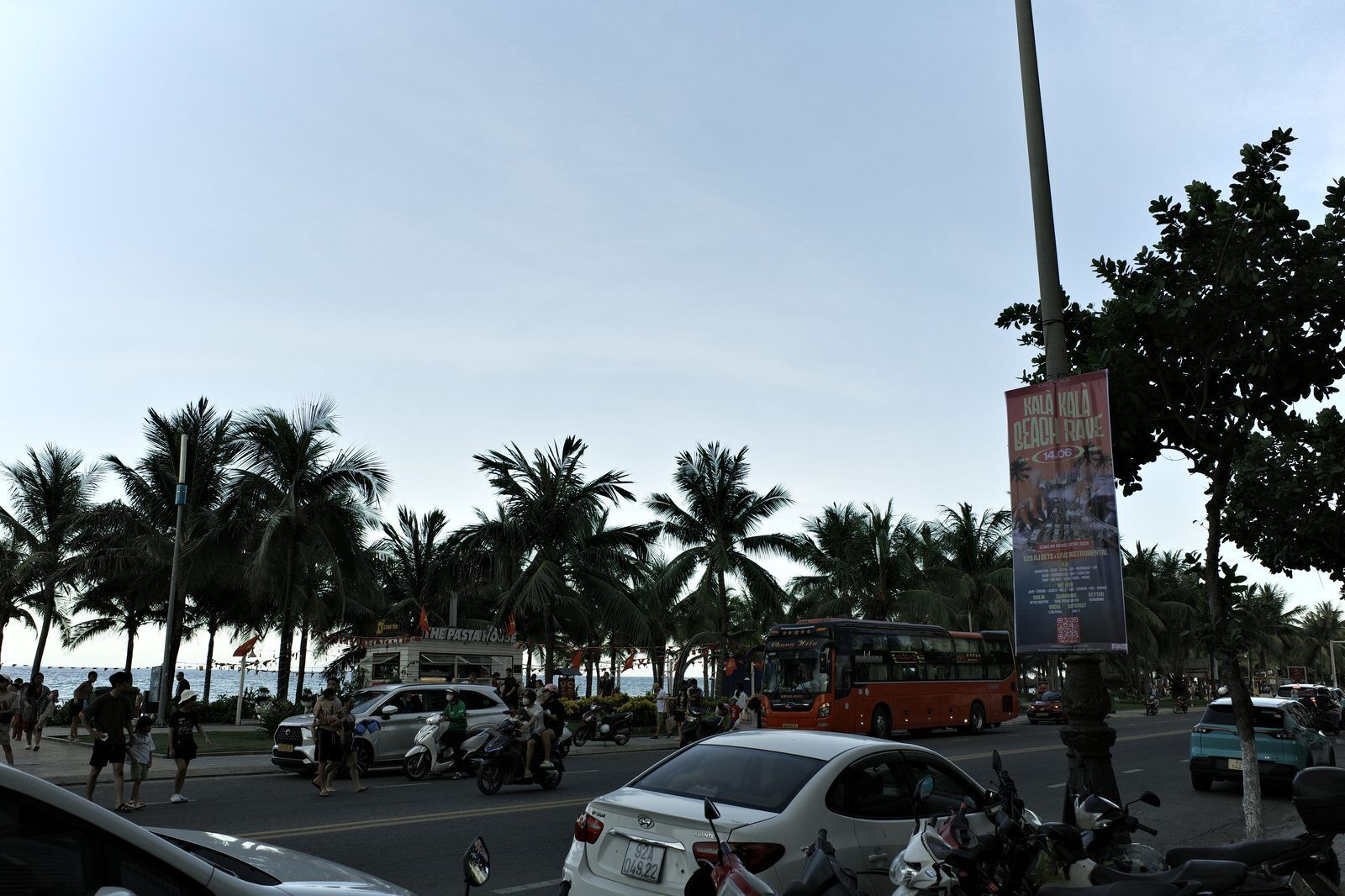 Vo Nguyen Giap beach road in Da Nang at dusk with palm trees and evening crowds heading to My Khe Beach