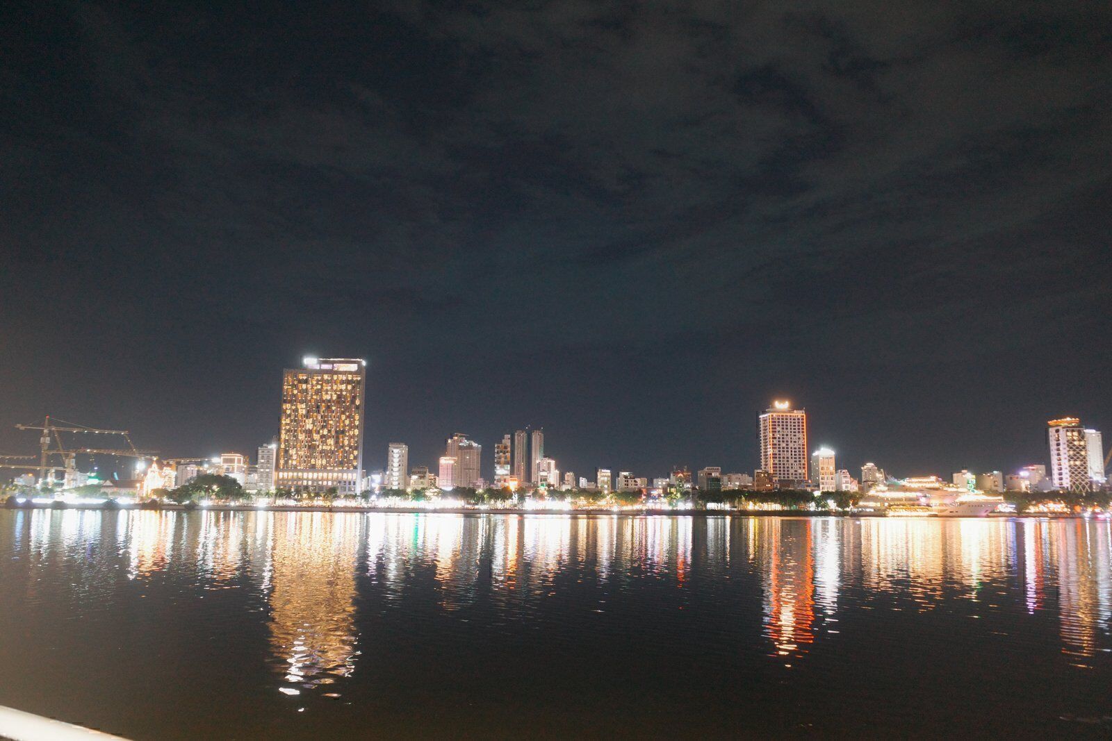Da Nang city skyline at night reflected in the calm Han River
