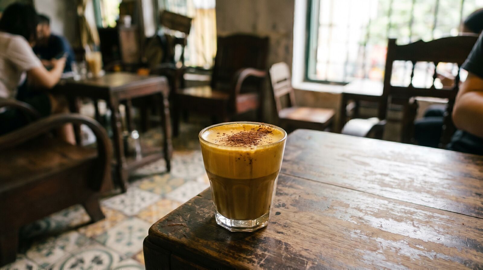 Vietnamese egg coffee with golden foam at a Hanoi cafe