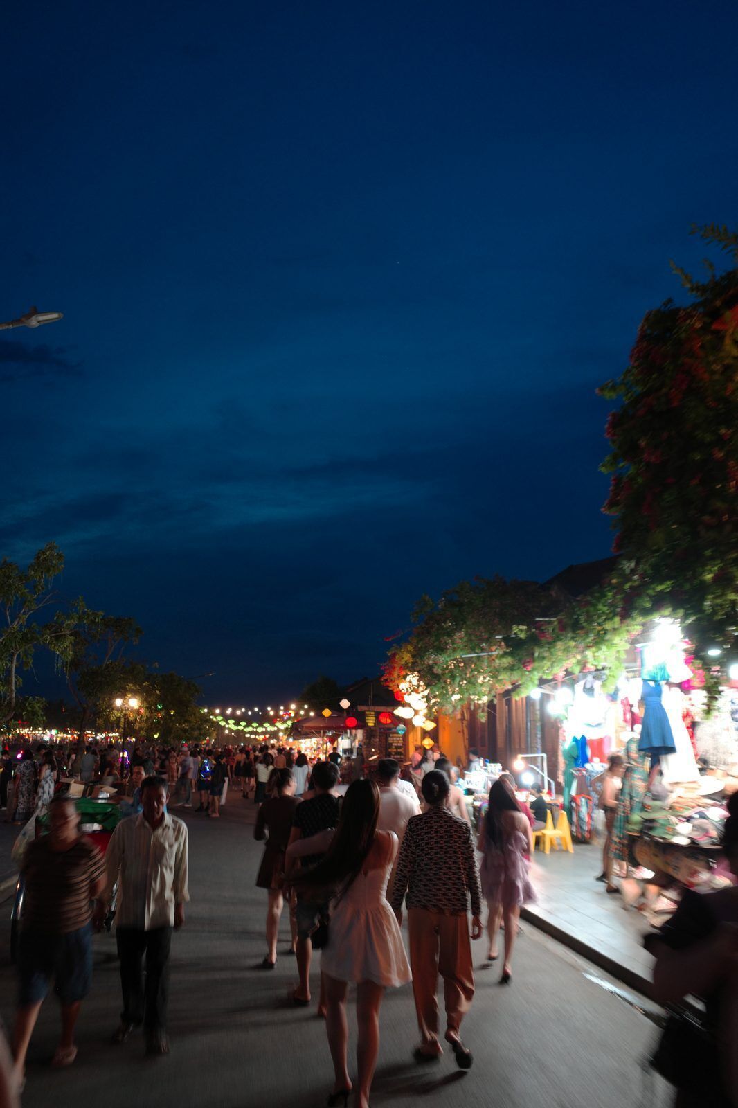 Hoi An night market street with lanterns and evening crowds by the Thu Bon River