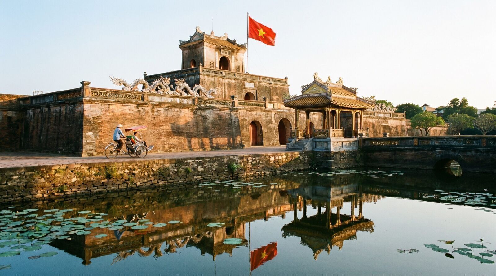 Ngo Mon gate of Hue Imperial Citadel with moat reflection