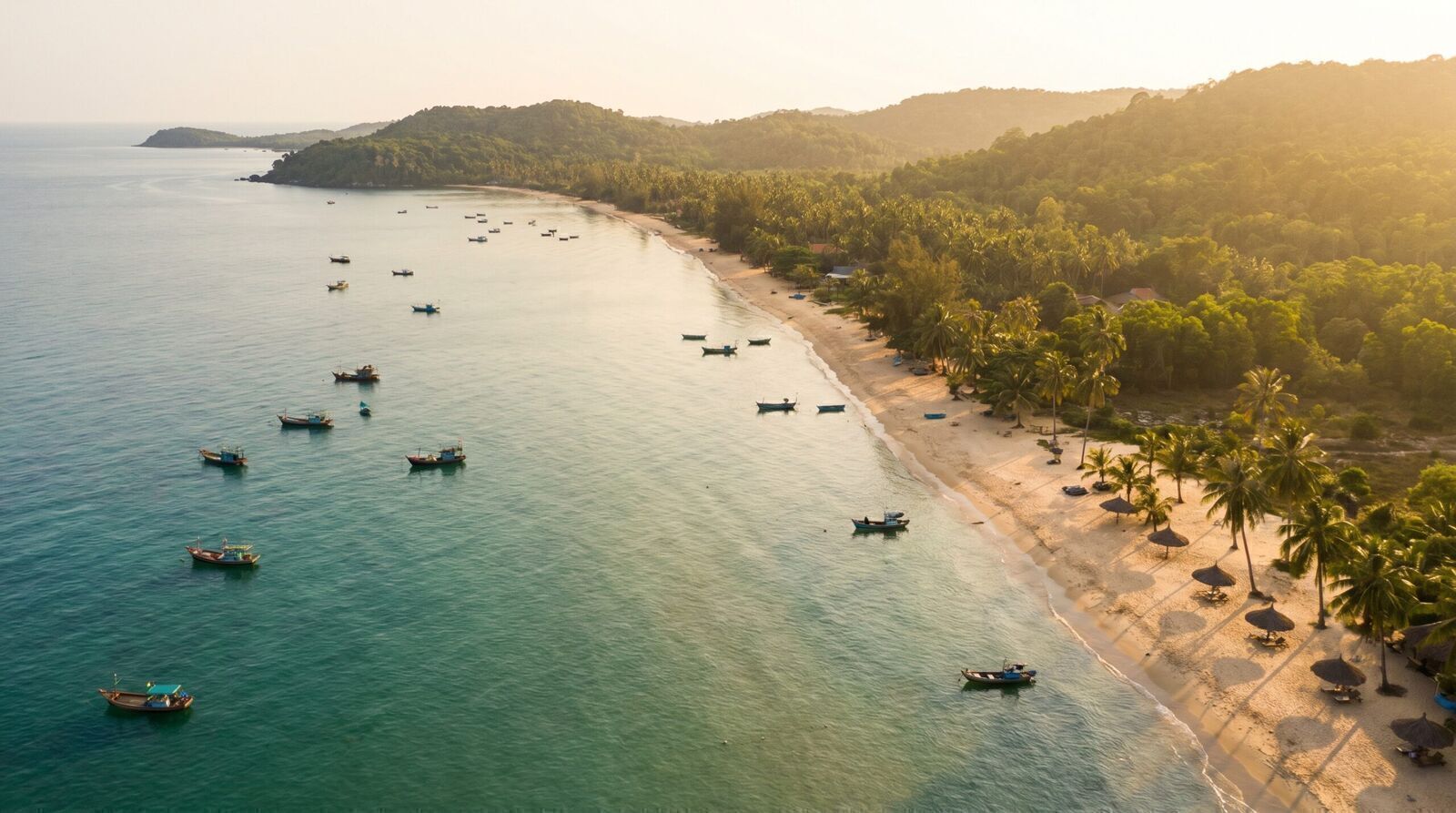Golden hour aerial panorama of Phu Quoc island coastline with fishing boats and palm trees