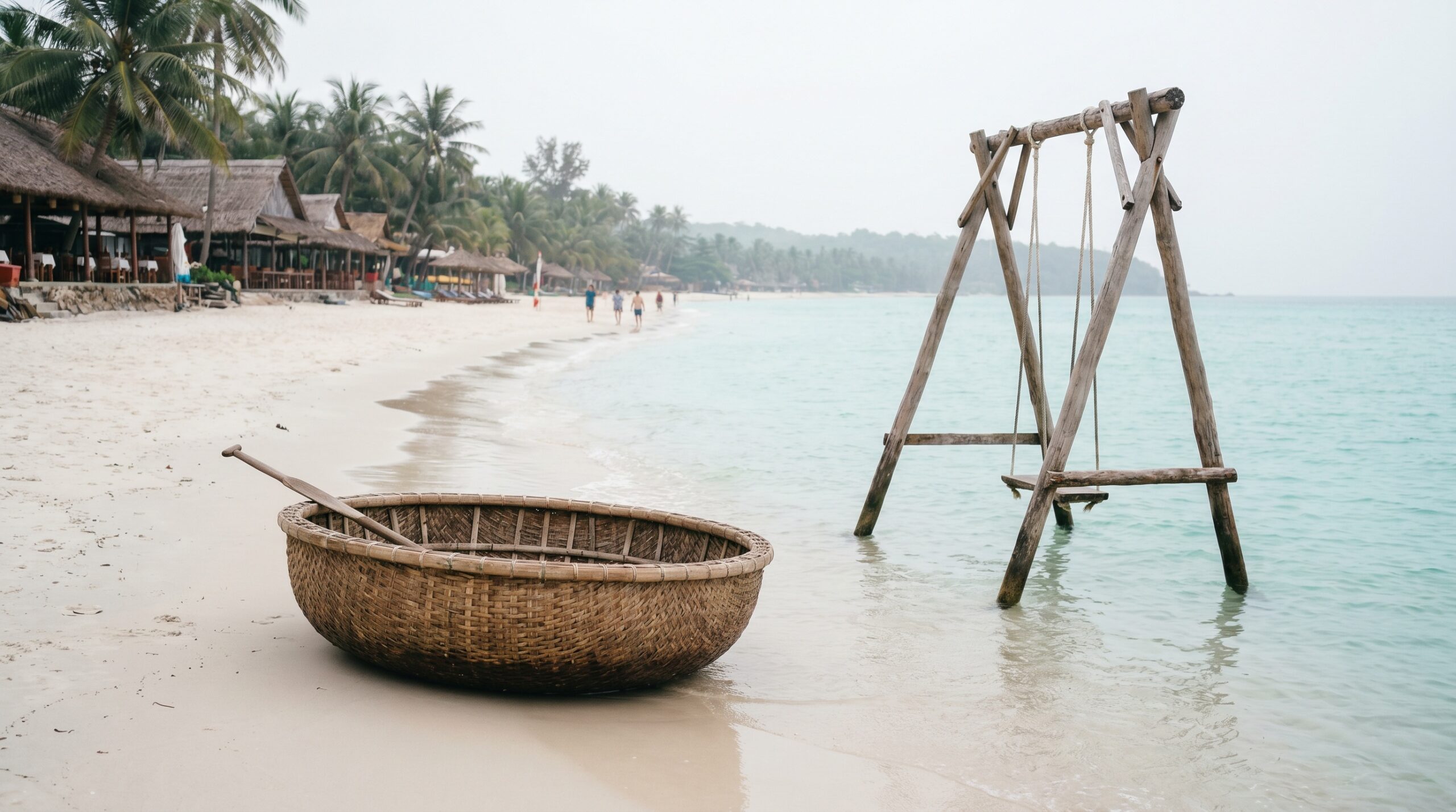 White sand at Sao Beach Phu Quoc with traditional basket boat and ocean swing