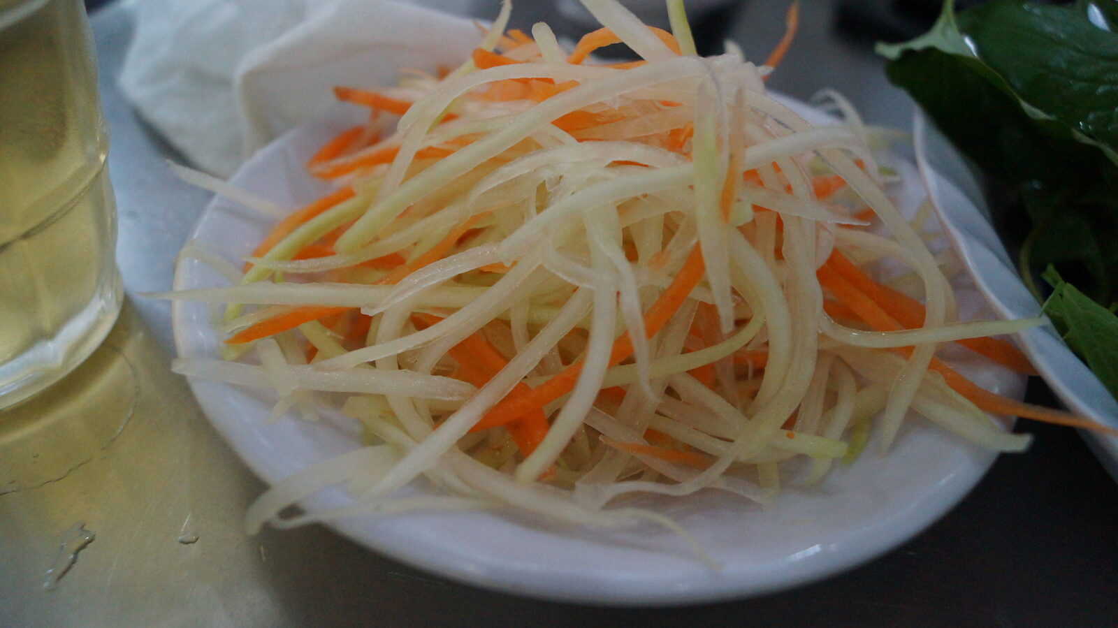 Plate of shredded green papaya and carrot pickle served with banh khot in Vung Tau