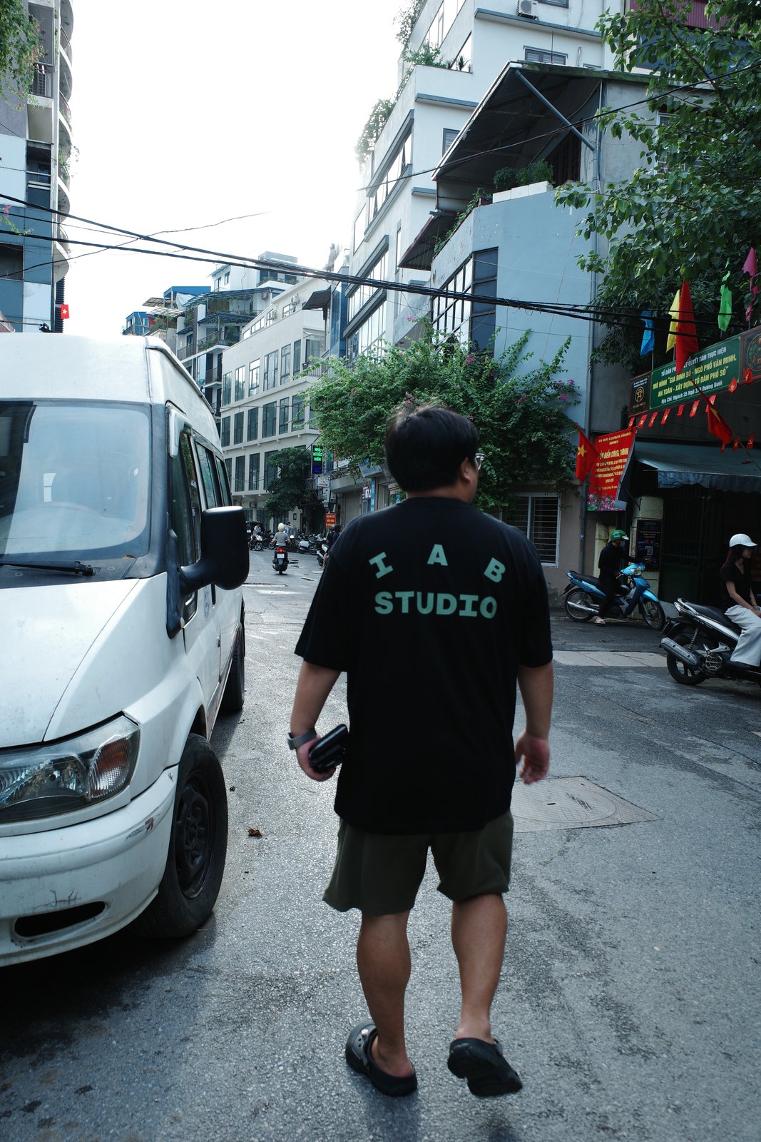 Dongmin Seo walking through a Hanoi alley, August 2026